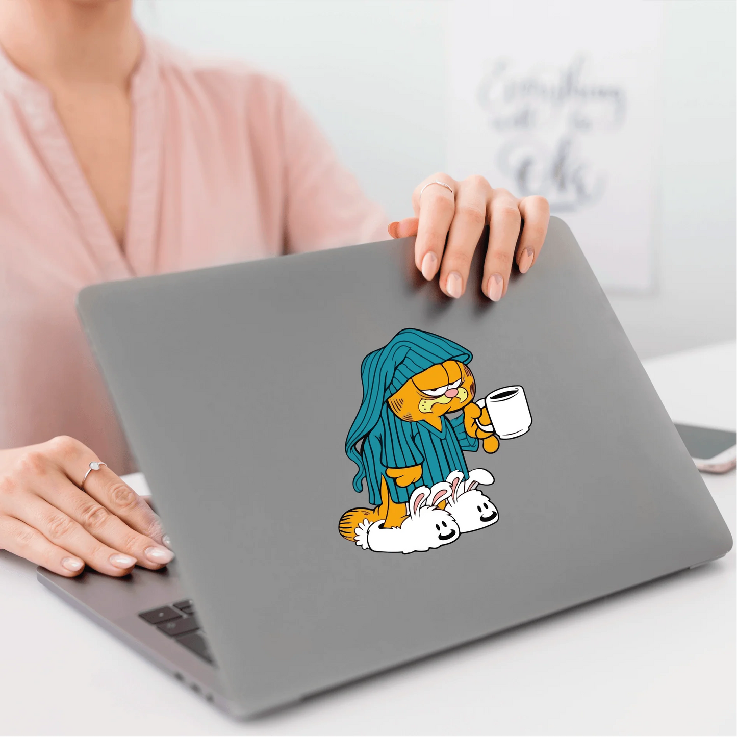 a woman sitting at a table with a laptop