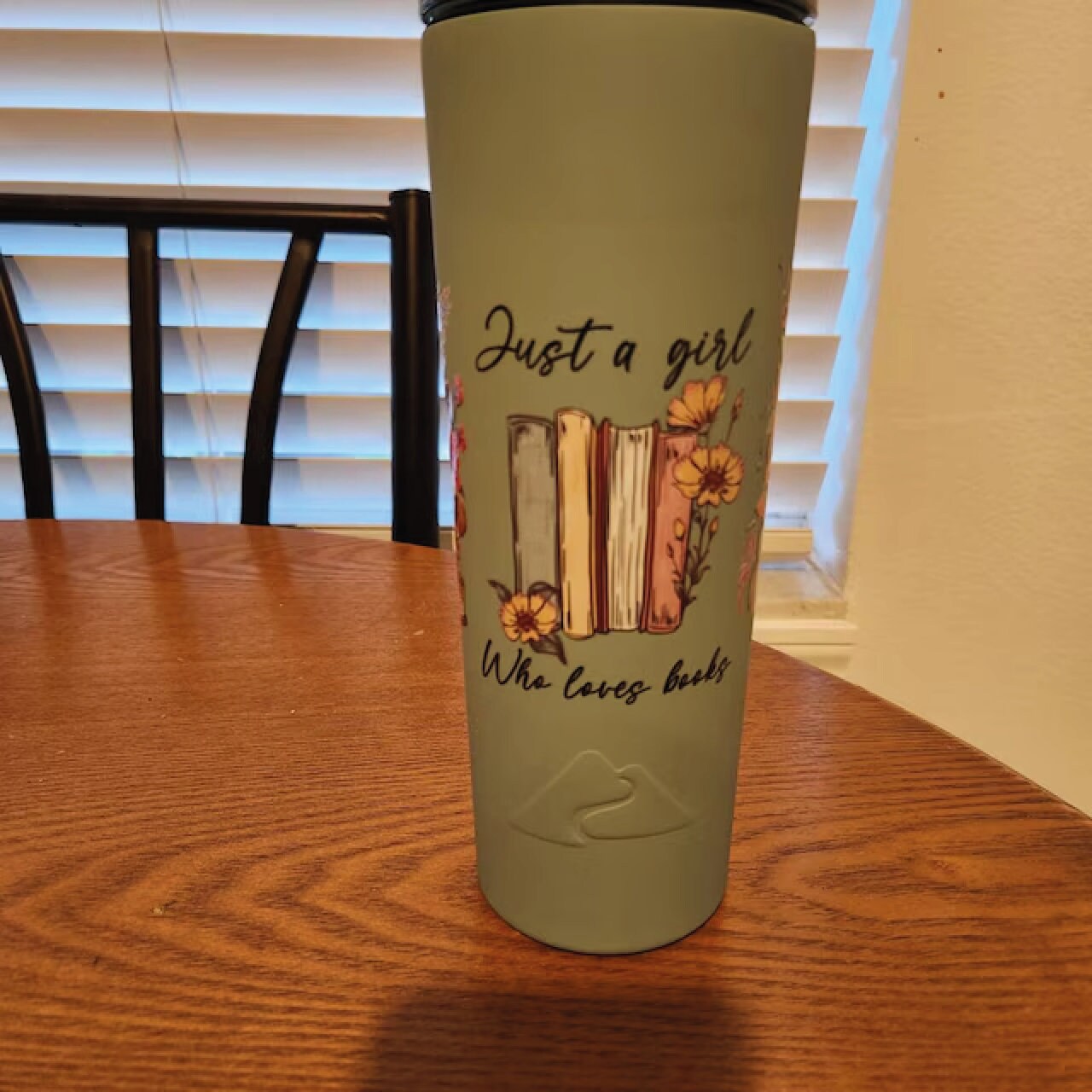 a cup with a book on it sitting on a table