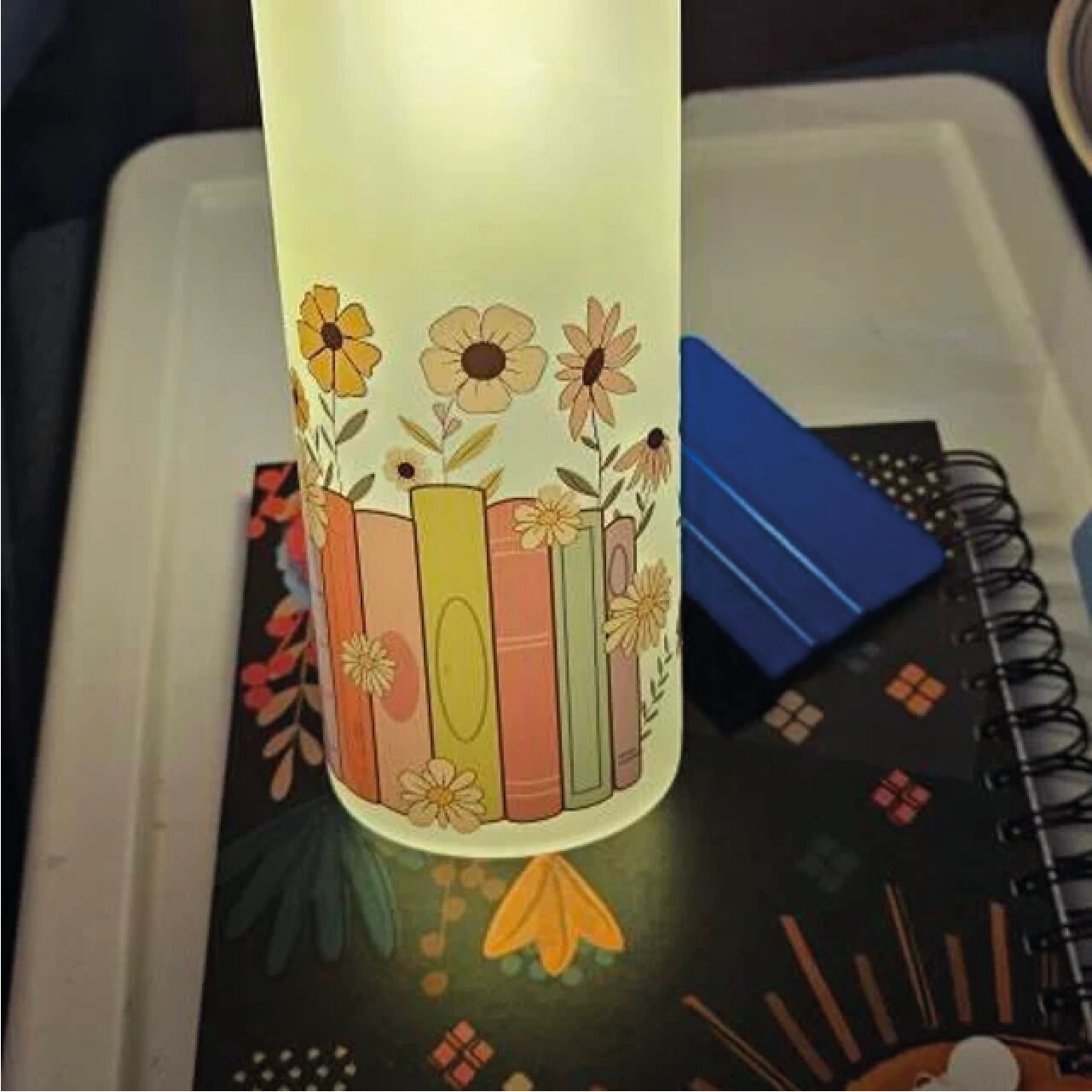 a lit up vase sitting on top of a table